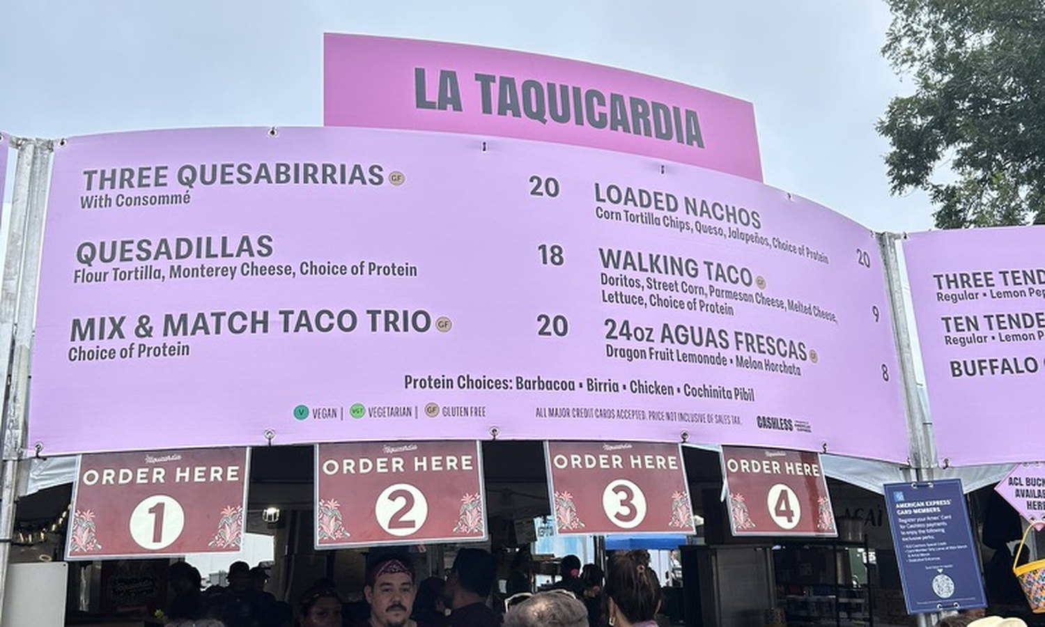 La Taquicardia's board: nachos $20, quesabirrias $20, a taco trio $20.