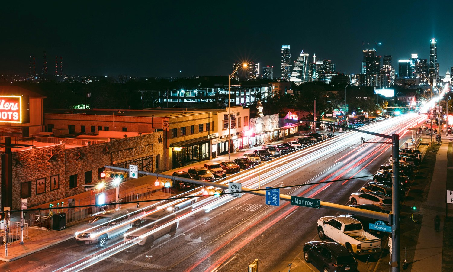 South Congress after dark. Book rides early, since race weekend surge pricing hits hard after midnight. Photo: Steven Pahel / Unsplash